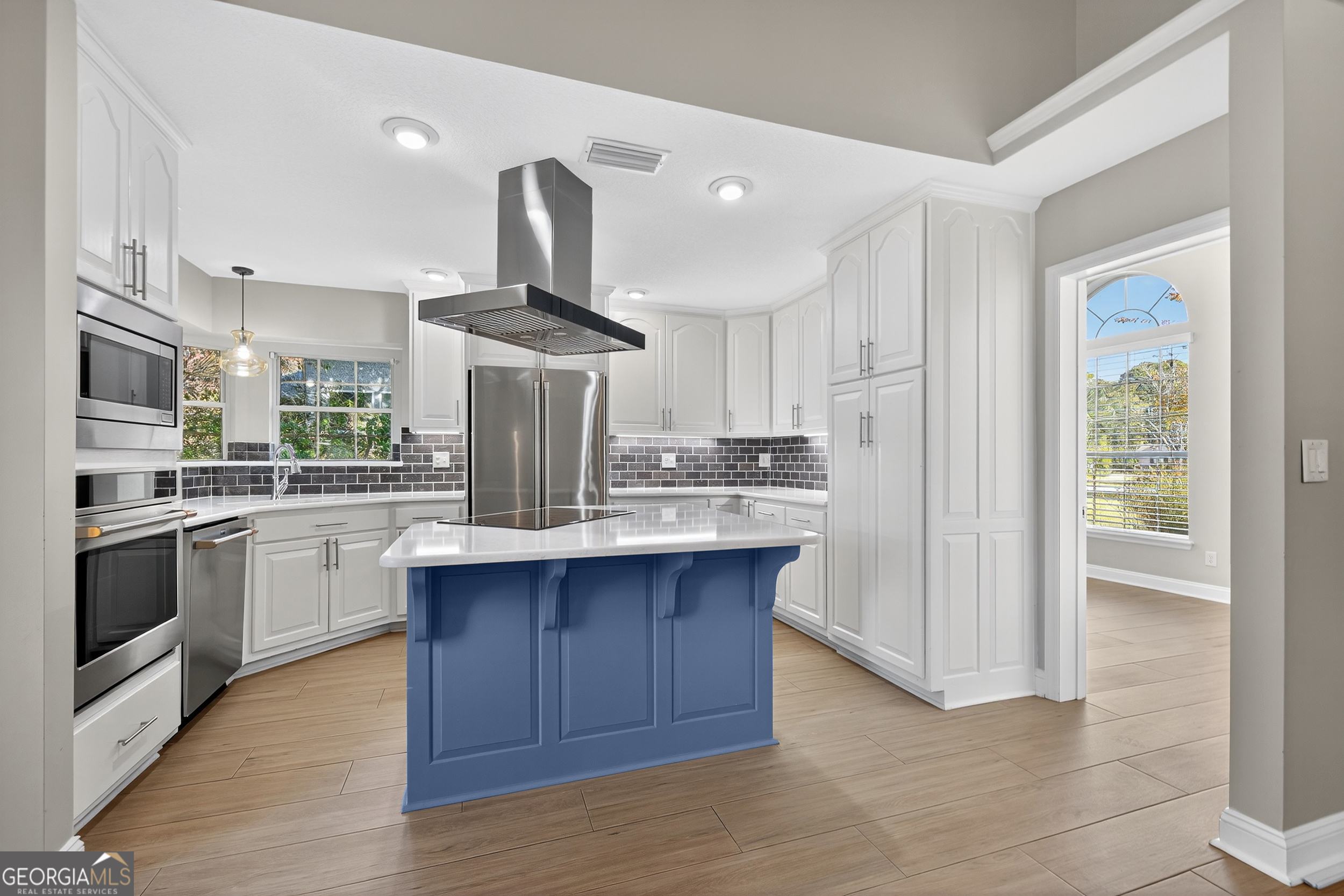 404 Morning Glory Road St. Marys, GA 31558 - Photo 3 of 34 a kitchen with stainless steel appliances a sink and wooden floor