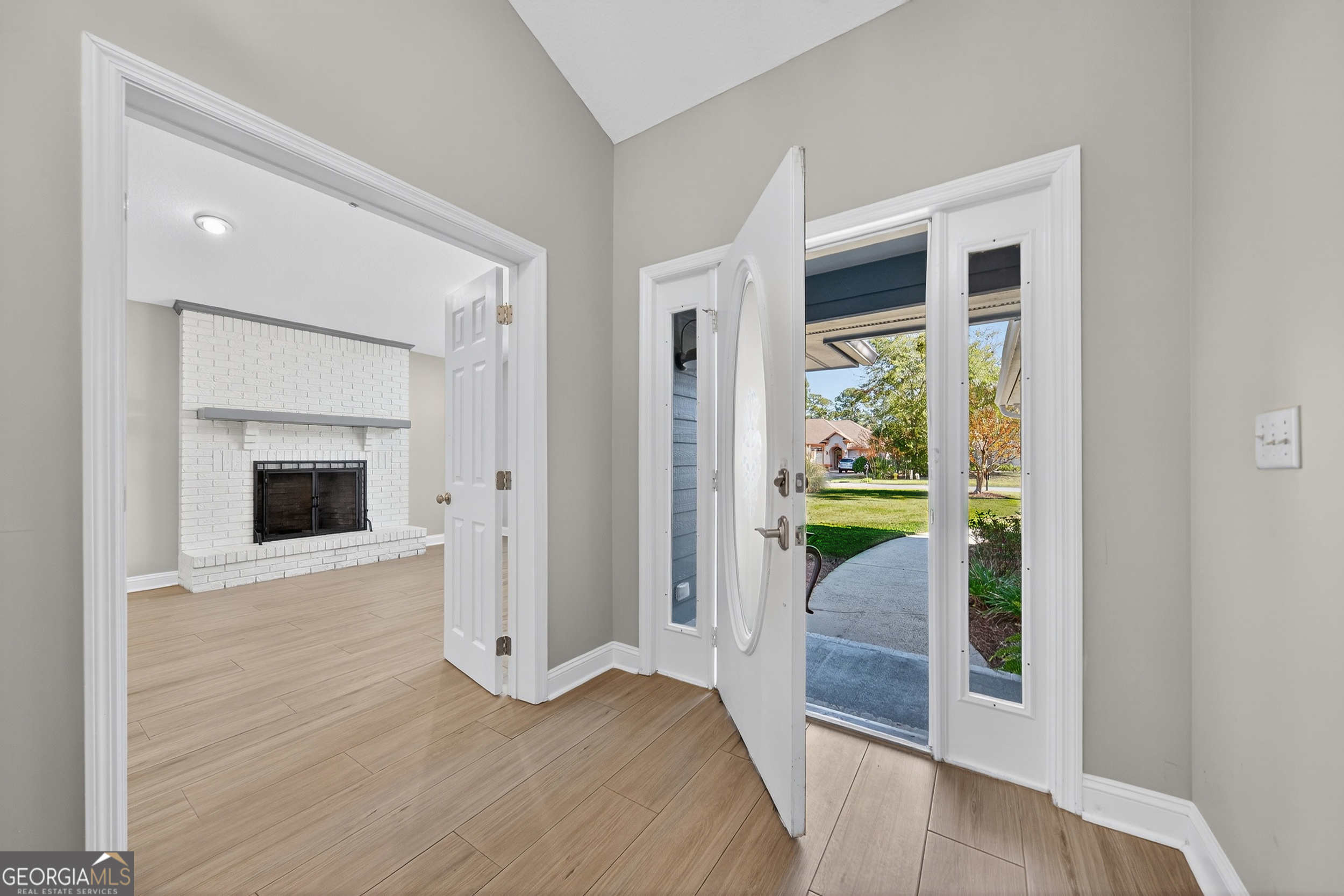 404 Morning Glory Road St. Marys, GA 31558 - Photo 7 of 34 a view of a hallway with wooden floor and a living room