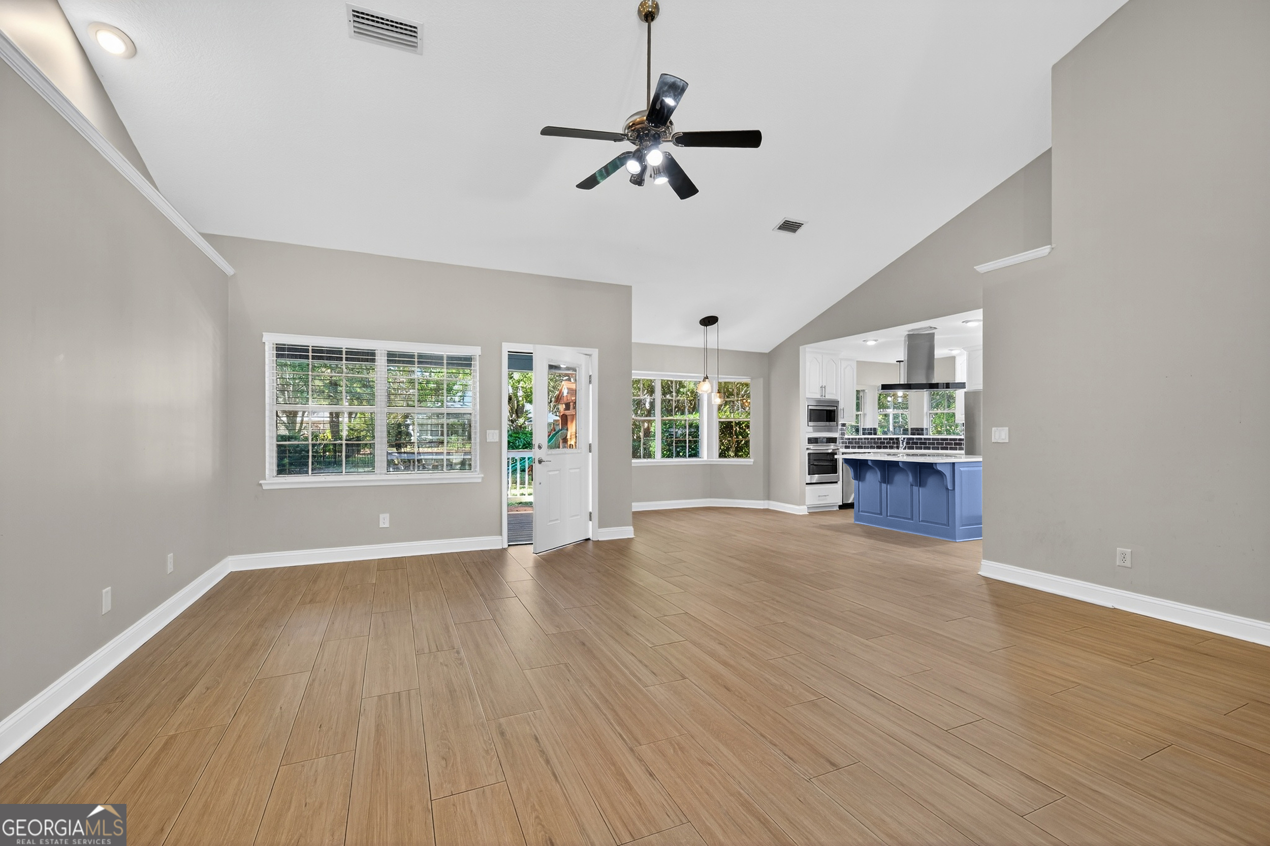 404 Morning Glory Road St. Marys, GA 31558 - Photo 8 of 34 a view of an empty room with a window and wooden floor