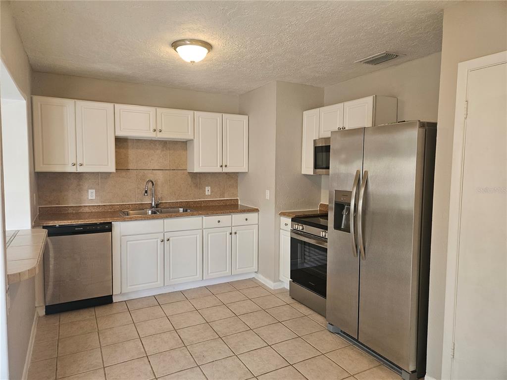 7000 Brentford Road Sarasota, FL 34241 - Photo 8 of 29 a kitchen with cabinets stainless steel appliances and a counter space