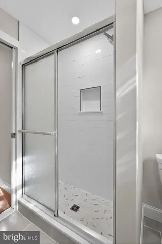 a bathroom with a glass shower door