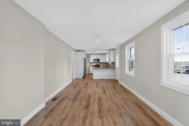 a view of kitchen with sink and wooden floor