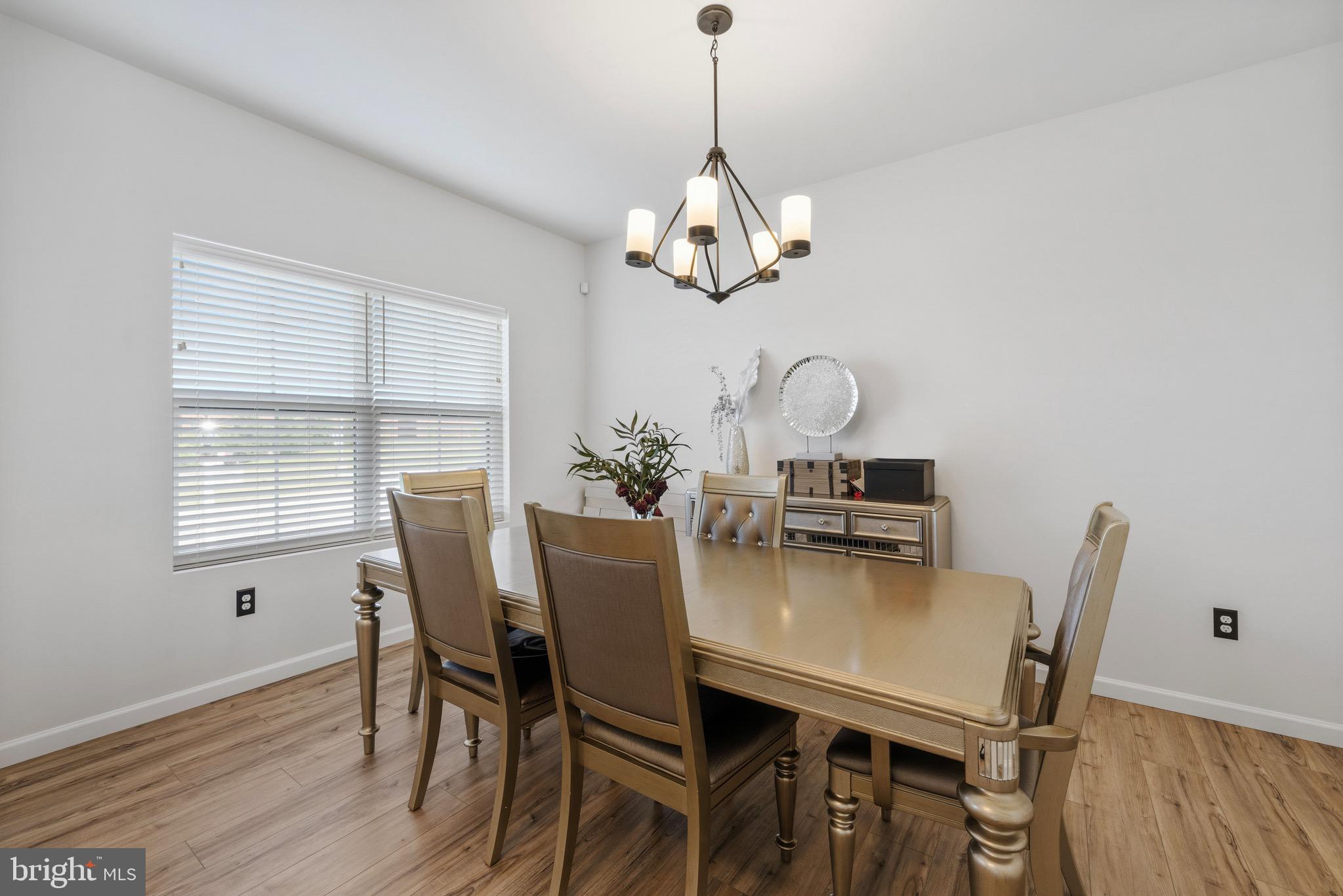 79 Beck Road York, PA 17403 - Photo 11 of 38 a view of a dining room with furniture a chandelier and wooden floor