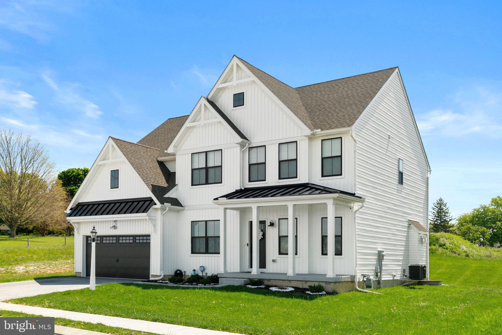 79 Beck Road York, PA 17403 - Photo 2 of 38 a view of a white house with a big yard and potted plants