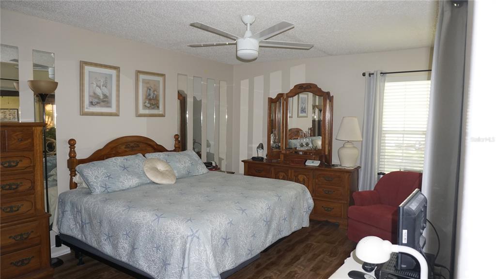 11241 Versailles Lane Port Richey, FL 34668 - Photo 14 of 38 a bedroom with a bed mirror and window