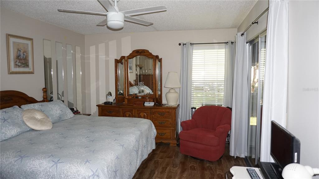 11241 Versailles Lane Port Richey, FL 34668 - Photo 15 of 38 a bedroom with furniture and a large window