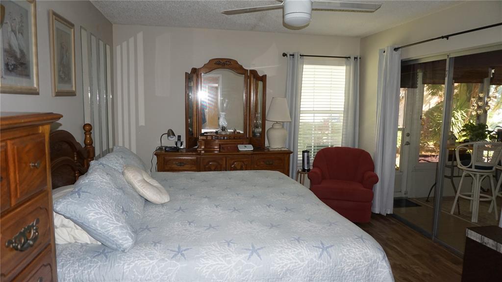 11241 Versailles Lane Port Richey, FL 34668 - Photo 16 of 38 a bed room with furniture and a large window