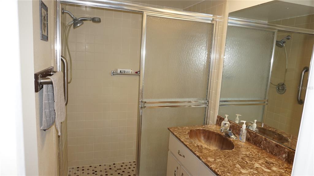 11241 Versailles Lane Port Richey, FL 34668 - Photo 17 of 38 a bathroom with a granite countertop shower sink and vanity