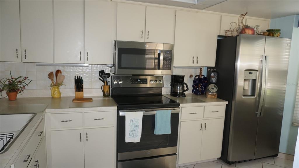 11241 Versailles Lane Port Richey, FL 34668 - Photo 2 of 38 a kitchen with appliances a sink and cabinets