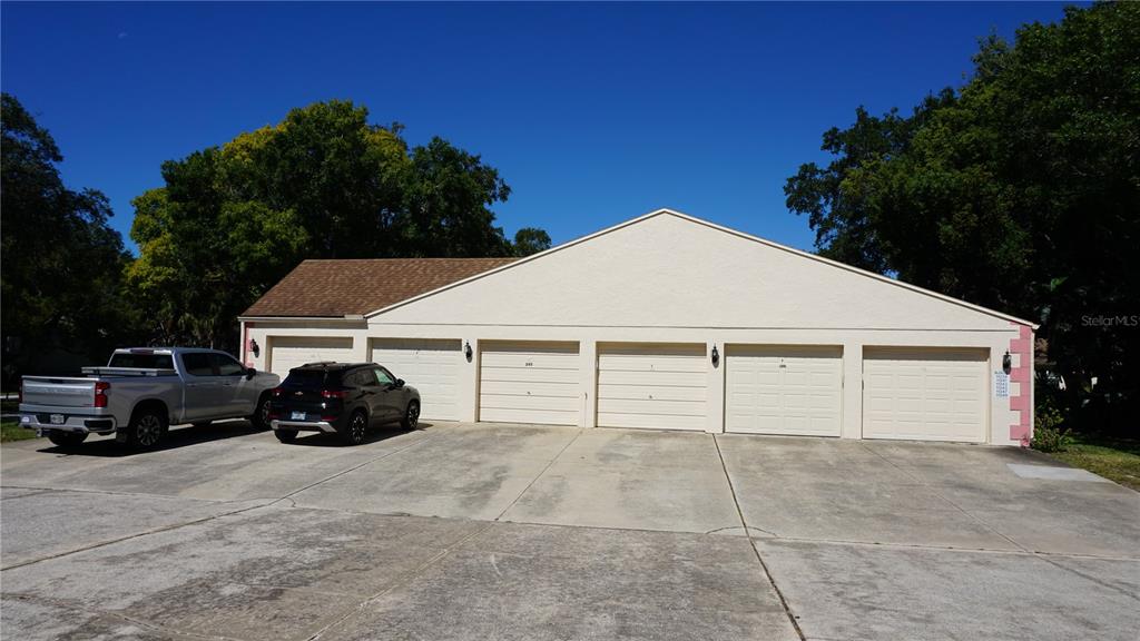11241 Versailles Lane Port Richey, FL 34668 - Photo 24 of 38 a view of a house with a garage