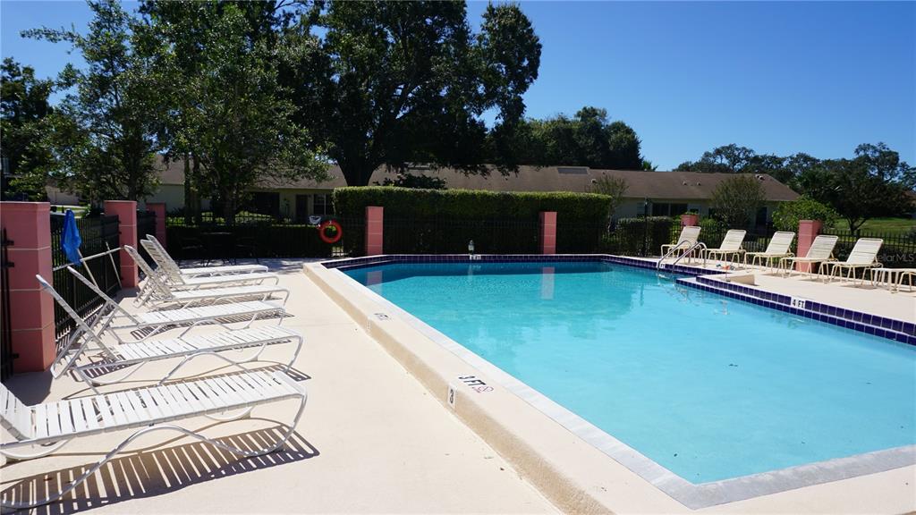 11241 Versailles Lane Port Richey, FL 34668 - Photo 27 of 38 a view of a patio with swimming pool table and chairs