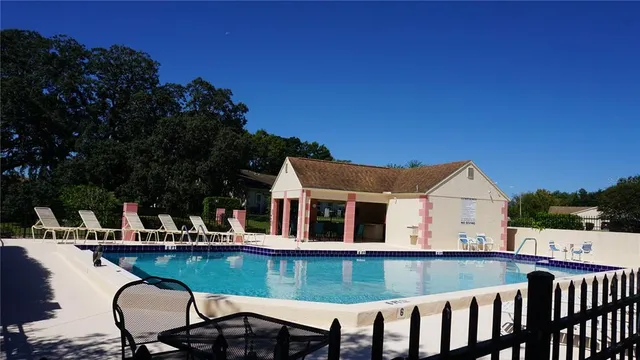 a view of a house with a swimming pool and sitting area