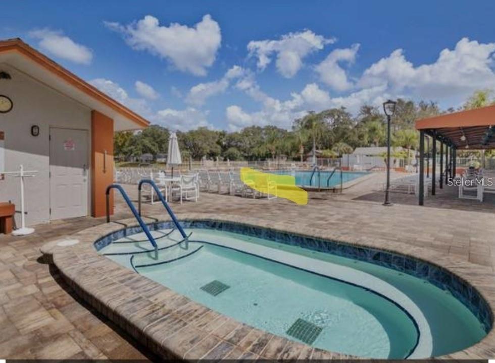 11241 Versailles Lane Port Richey, FL 34668 - Photo 33 of 38 a view of a swimming pool with a lounge chair
