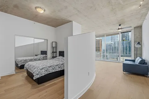 a bedroom with a large bed and a large window