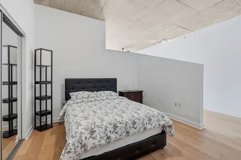 a bedroom with a bed and a book shelf