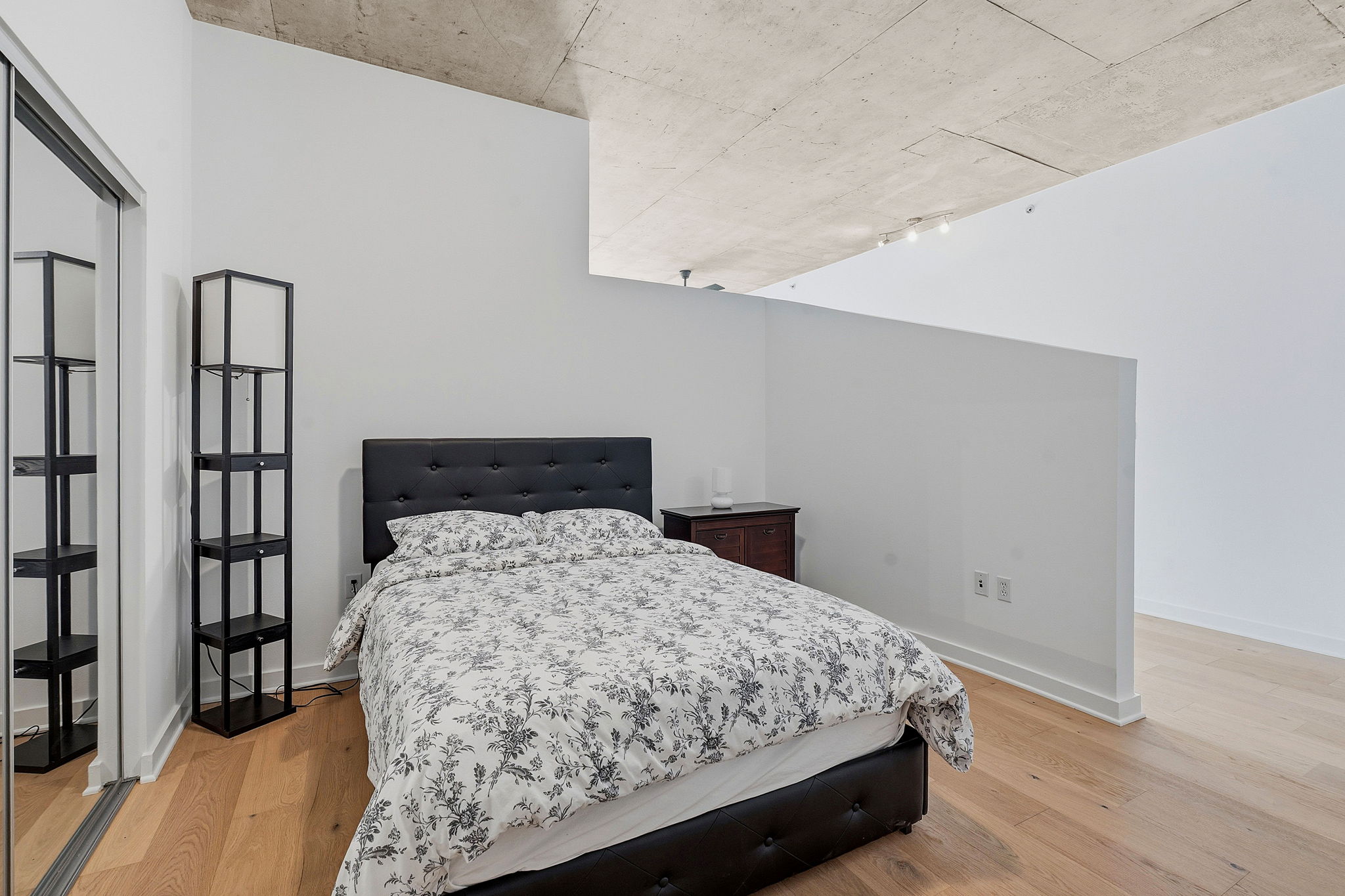 360 Nueces Street, Unit 1303 Austin, TX 78701 - Photo 12 of 40 a bedroom with a bed and a book shelf