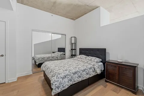 a bedroom with a bed and two dresser