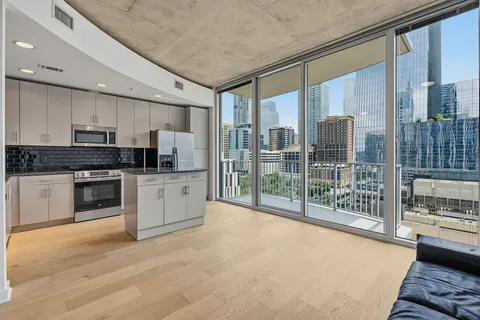 a kitchen with stainless steel appliances a refrigerator and a stove top oven