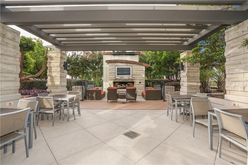360 Nueces Street, Unit 1303 Austin, TX 78701 - Photo 27 of 40 a view of a patio with table and chairs floor to ceiling window with plants