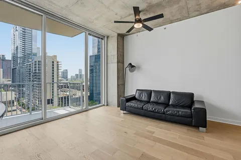 a living room with furniture and a ceiling fan
