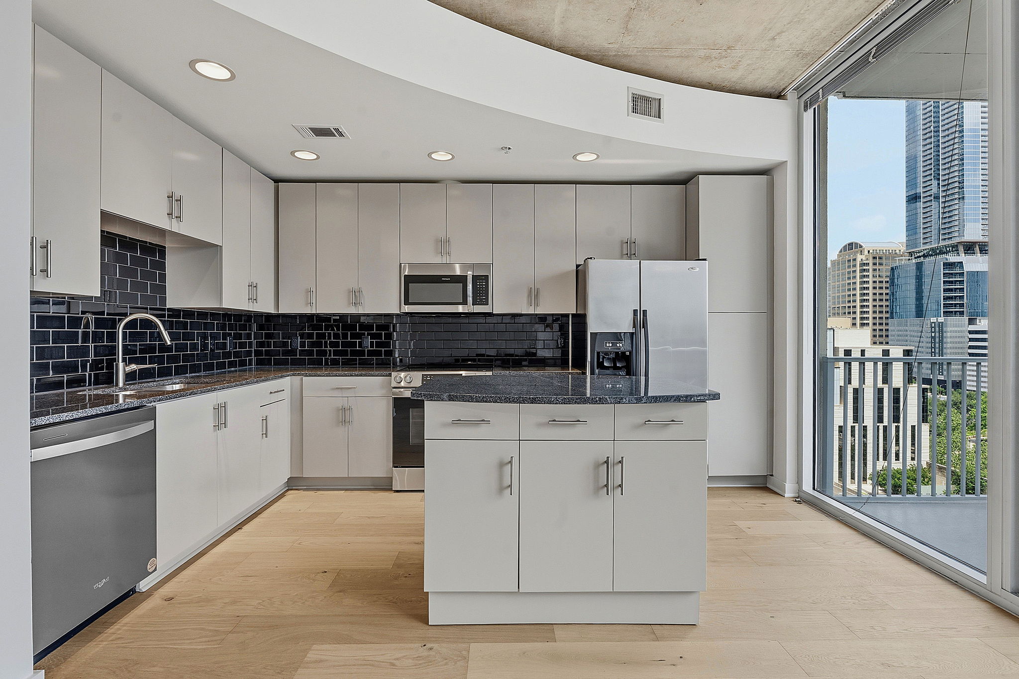360 Nueces Street, Unit 1303 Austin, TX 78701 - Photo 8 of 40 a kitchen with stainless steel appliances granite countertop a stove a sink and a refrigerator