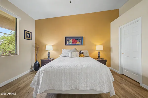 a bedroom with a bed and wooden floor