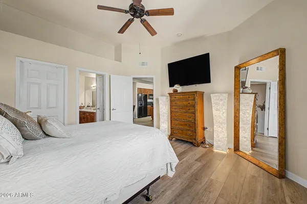 a bedroom with a bed and a painting on the wall