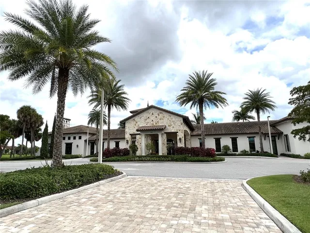 a view of swimming pool with a yard and palm trees