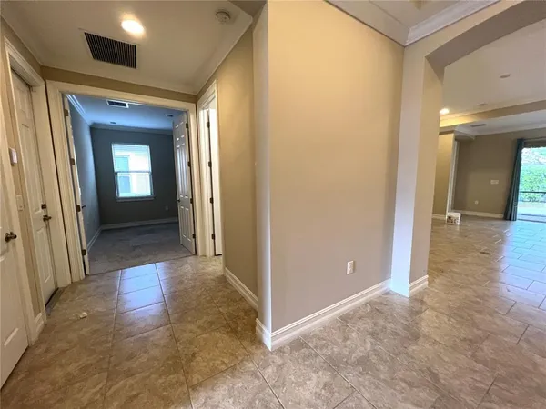 a view of a hallway with wooden floor and a living room