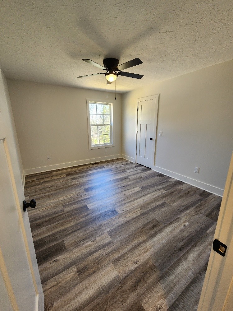 670 Armstrong Road Castalian Springs, TN 37031 - Photo 13 of 25 wooden floor in an empty room with a window