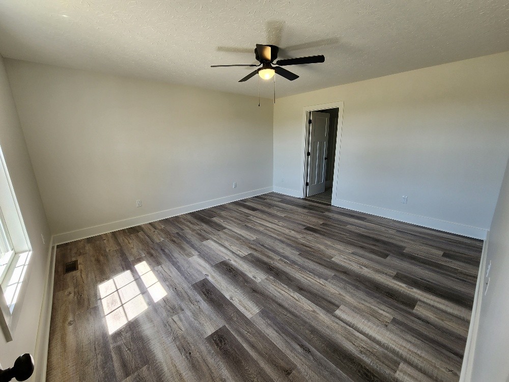 670 Armstrong Road Castalian Springs, TN 37031 - Photo 15 of 25 a view of empty room with wooden floor and fan