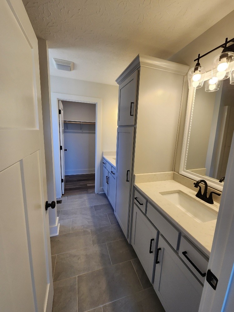 670 Armstrong Road Castalian Springs, TN 37031 - Photo 16 of 25 a bathroom with a double vanity sink and mirror