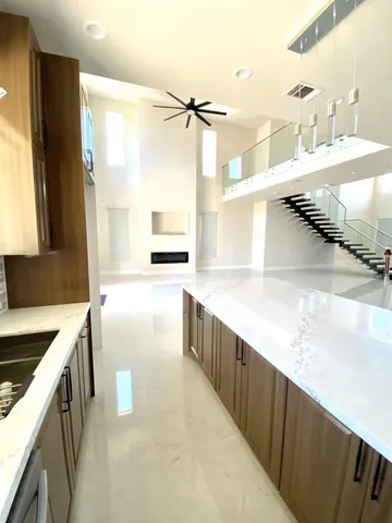 a kitchen with kitchen island a sink stove and refrigerator