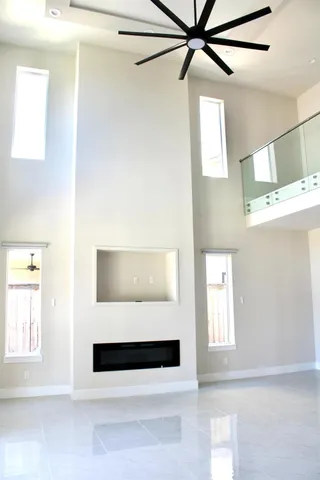 a living room with a bed and a window