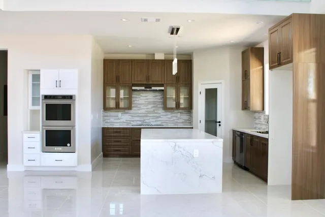 a large kitchen with cabinets and stainless steel appliances
