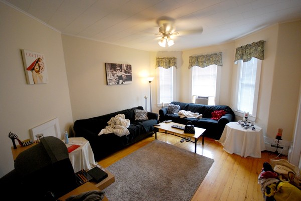 186 L Street, Unit 3 Boston, MA 02127 - Photo 1 of 1 a living room with furniture and a chandelier