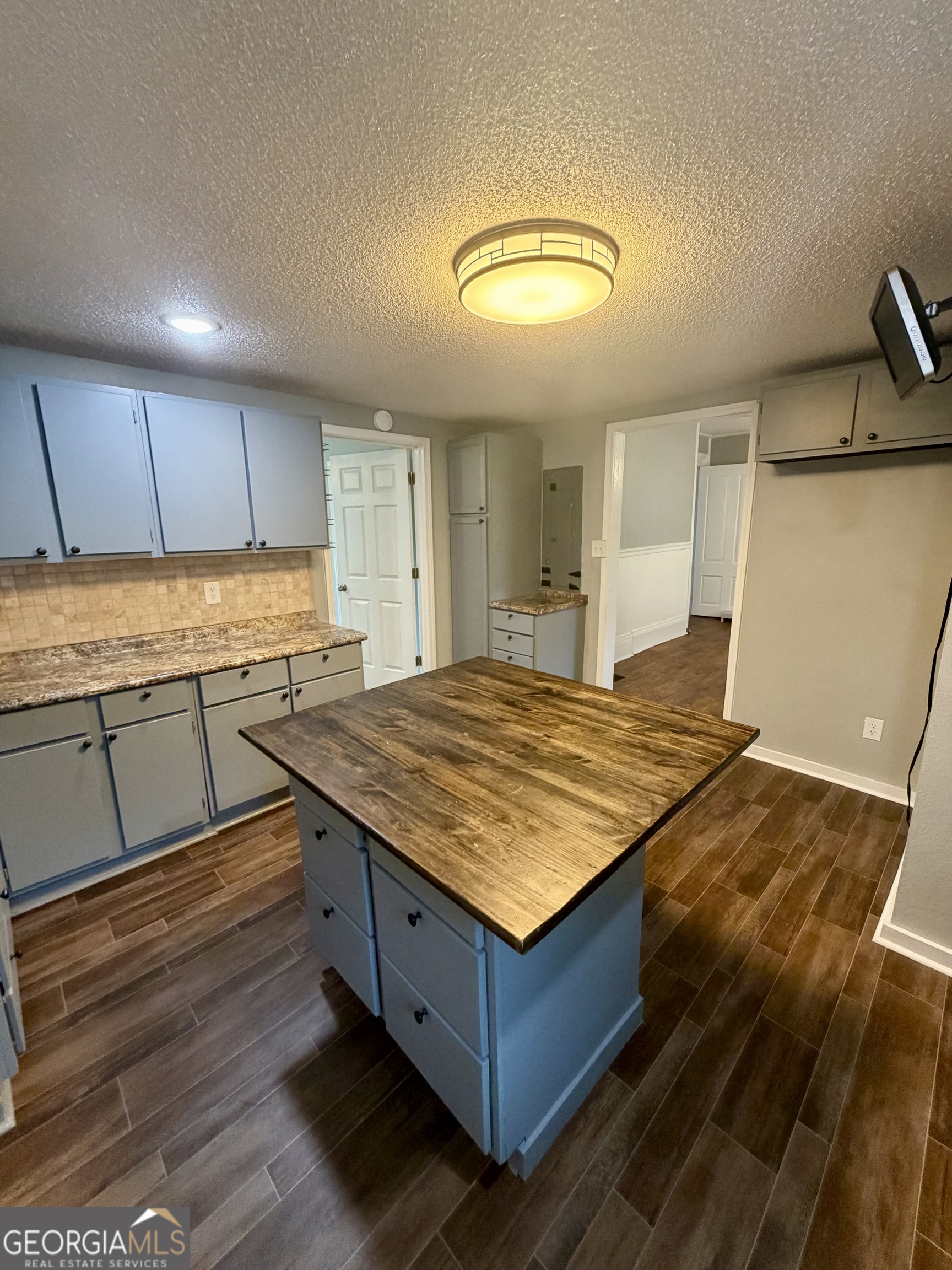 666 Woolfolk Street Macon, GA 31217 - Photo 31 of 60 a kitchen with kitchen island a sink appliances and cabinets