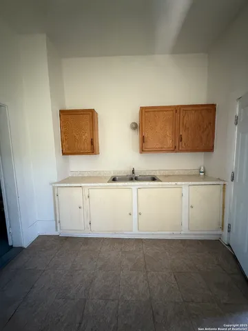 a living room with hardwood floor and a large window