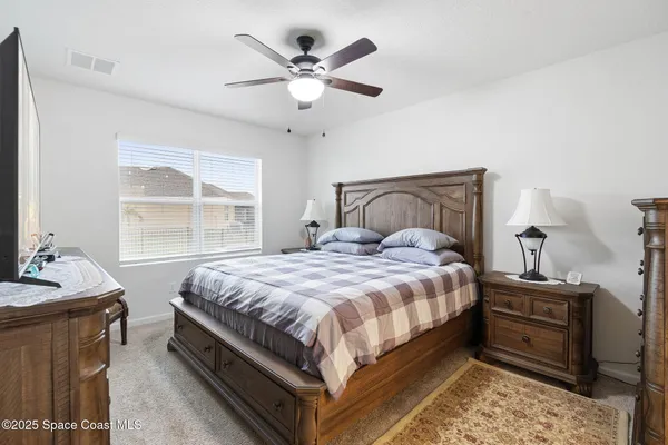 a bedroom with a bed and window