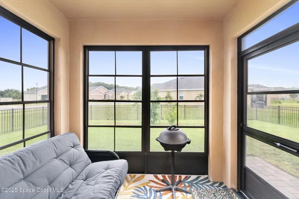a bedroom with furniture and a large window