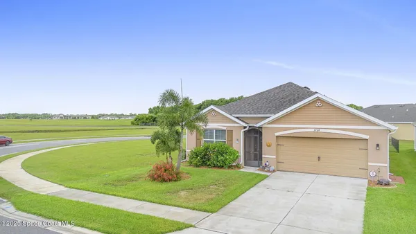 a view of a house with a swimming pool and a yard