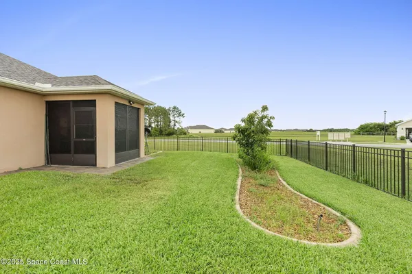 a view of a house with a backyard and a garden