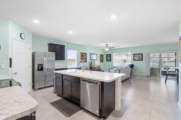 a room with a sink a table and chairs