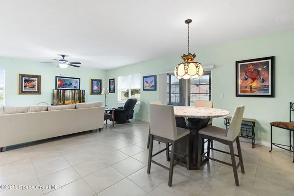 a dining room with a table and chairs