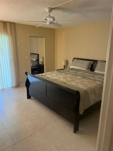 a room with a bed and a chandelier