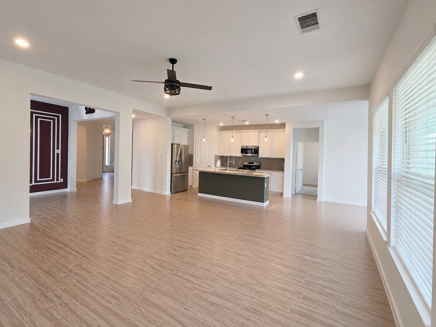 5035 Sierra Ridge Drive Rosenberg, TX 77469 - Photo 8 of 26 Discover a spacious, open-concept family room seamlessly flowing into the modern kitchen, perfect for effortless entertaining and cozy family gatherings.