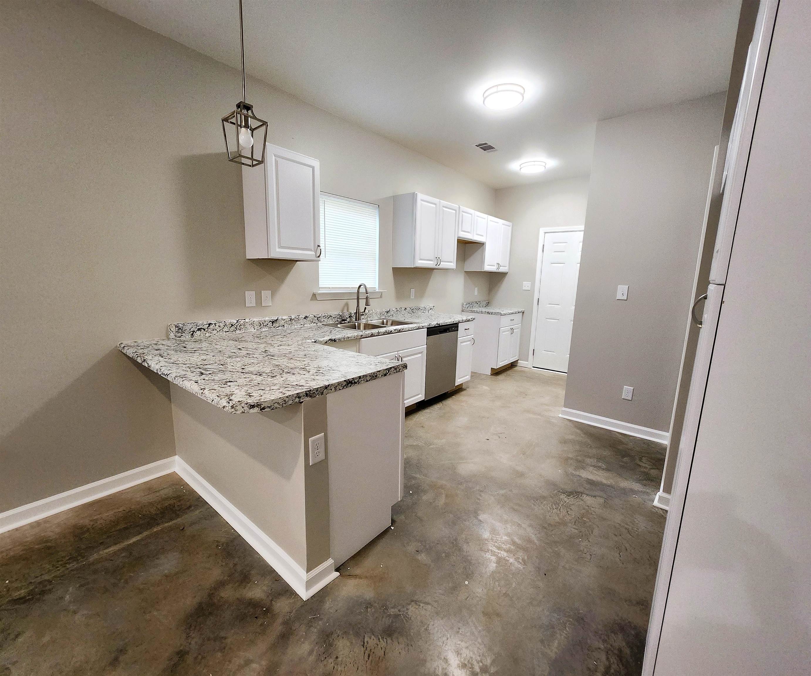 1249 Marksman Street Memphis, TN 38106 - Photo 4 of 10 a kitchen with a sink stove and cabinets