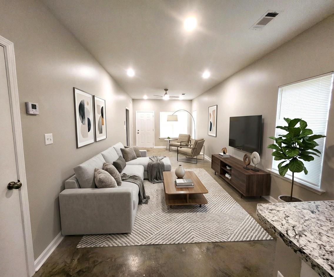 1249 Marksman Street Memphis, TN 38106 - Photo 5 of 10 a living room with furniture and a flat screen tv