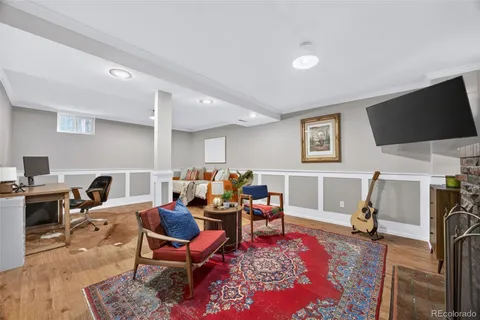 a living room with furniture a flat screen tv and kitchen view