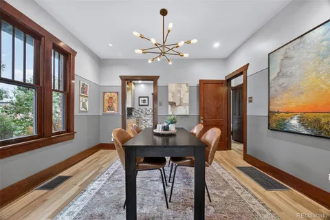 a view of a dining room with furniture window and wooden floor